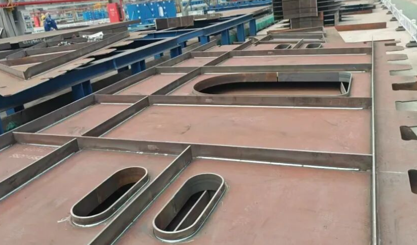 Large ship hull panel assembly with longitudinal and transverse stiffeners prepared for RA series robotic welding