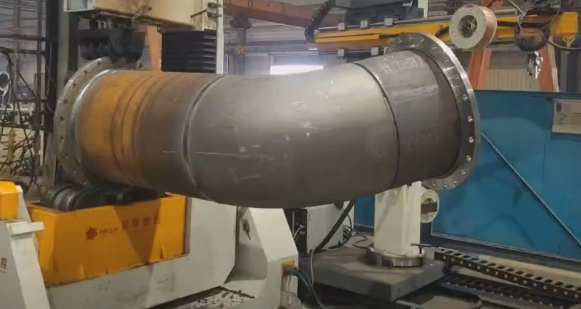 Cylindrical ship tank component mounted on a rotary positioner for welding by a DONSIN RW collaborative welding robot